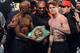 LAS VEGAS, NV - SEPTEMBER 13: CEO of Mayweather Promotions Leonard Ellerbe (C) looks on as boxer Floyd Mayweather Jr. (L) tries to get boxer Canelo Alvarez (R) to hold a WBC belt as they pose during the official weigh-in for their bout at the MGM Grand Garden Arena on September 13, 2013 in Las Vegas, Nevada. The fighters will meet in a WBC/WBA 154-pound title fight on September 14 in Las Vegas. (Photo by Ethan Miller/Getty Images)