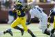 ANN ARBOR, MI - SEPTEMBER 14: Fitzgerald Toussaint #28 of the Michigan Wolverines tries to outrun the tackle of C.J. James #9 of the Akron Zips during the first quarter at Michigan Stadium on September 14, 2013 in Ann Arbor, Michigan. (Photo by Gregory Shamus/Getty Images)