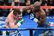 LAS VEGAS, NV - SEPTEMBER 14: Floyd Mayweather Jr. (R) hits Canelo Alvarez in the fifth round of their WBC/WBA 154-pound title fight at the MGM Grand Garden Arena on September 14, 2013 in Las Vegas, Nevada. Mayweather won by majority decision. (Photo by Ethan Miller/Getty Images)