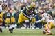 GREEN BAY, WI - SEPTEMBER 15: James Starks #44 of the Green Bay Packers rushes the ball and is hit by Reed Doughty #37 of the Washington Redskins at Lambeau Field on September 15, 2013 in Green Bay, Wisconsin. The Packers defeated the Redskins 38-20. (Photo by Wesley Hitt/Getty Images)