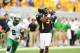 Sep 1, 2012; Morgantown, WV, USA; West Virginia Mountaineers wide receiver Ivan McCartney (5) catches a pass as Marshall Thundering Herd defensive back Tron Martinez (2) defends in the fourth quarter at Milan Puskar Stadium. Mandatory Credit: James Lang-USA TODAY Sports