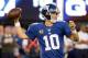 Sep 15, 2013; East Rutherford, NJ, USA; New York Giants quarterback Eli Manning (10) throws a pass against the Denver Broncos in the 4th quarter during the game at MetLife Stadium. Mandatory Credit: Robert Deutsch-USA TODAY Sports