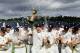 CHESTER-LE-STREET, ENGLAND - SEPTEMBER 19: Durham captain Paul Collingwood (c) and team celebrate with the trophy after winning the LV County Championship Division One title after day three of the LV County Championship Division One match between Durham and Nottinghamshire at The Riverside on September 19, 2013 in Chester-le-Street, England. (Photo by Stu Forster/Getty Images)