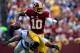 LANDOVER, MD - SEPTEMBER 22: Robert Griffin III #10 of the Washington Redskins scrambles with the ball as he avoids the tackle of Ezekiel Ansah #94 of the Detroit Lions in the first half during a game at FedExField on September 22, 2013 in Landover, Maryland. (Photo by Patrick McDermott/Getty Images)