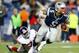 FOXBORO, MA - AUGUST 29: Tim Tebow #5 of the New England Patriots evades a tackle and runs with the ball past Adewale Ojomo #71 of the New York Giants during the preseason game at Gillette Stadium on August 29, 2013 in Foxboro, Massachusetts. (Photo by Jared Wickerham/Getty Images)