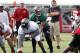Jul 26, 2013; Tampa, FL, USA;Tampa Bay Buccaneers quarterback Josh Freeman (5) calls a play as center Jeremy Zuttah (76) gets ready to hike the ball as head coach Greg Schiano watches during training camp at One Buccaneer Place. Mandatory Credit: Kim Klement-USA TODAY Sports