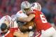 Nov 17, 2012; Madison, WI, USA; Ohio State Buckeyes quarterback Braxton Miller (5) is tackled by Wisconsin Badgers linebacker Mike Taylor (53) during the game at Camp Randall Stadium. Ohio State defeated Wisconsin 21-14 in overtime. Mandatory Credit: Jeff Hanisch-USA TODAY Sports
