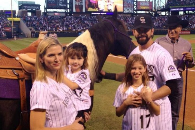 Colorado Rockies first baseman Todd Helton, right, gets a kiss from his  youngest daughter Gentry Grace and as his wife Christy holds her following  a news conference announcing his retirement from baseball