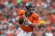 DENVER, CO - SEPTEMBER 29: Quarterback Peyton Manning #18 of the Denver Broncos rolls out of the pocket and looks for a receiver downfield against the Philadelphia Eagles at Sports Authority Field Field at Mile High on September 29, 2013 in Denver, Colorado. (Photo by Dustin Bradford/Getty Images)