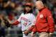 PITTSBURGH, PA - APRIL 13: Johnny Cueto #47 of the Cincinnati Reds walks off the field alongside trainer Paul Lessard after suffering soreness in his throwing arm during the fifth inning against the Cincinnati Reds on April 13, 2013 at PNC Park in Pittsburgh, Pennsylvania. (Photo by Joe Sargent/Getty Images)