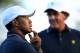 Oct 3, 2013; Dublin, OH, USA; Tiger Woods and Phil Mickelson wait on the 17th green during the Thursday four ball matches of the Presidents Cup at Muirfield Village Golf Club. Mandatory Credit: Peter Casey-USA TODAY Sports