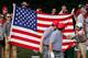 DUBLIN, OH - OCTOBER 04: A fan offers a toy squirrel to Keegan Bradley (L) and Phil Mickelson of the U.S. Team on the second hole during the Day Two Foursome Matches at the Muirfield Village Golf Club on October 4, 2013 in Dublin, Ohio. (Photo by Gregory Shamus/Getty Images)