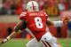 LINCOLN, NE - OCTOBER 5: Running back Ameer Abdullah #8 of the Nebraska Cornhuskers looks to avoid defensive back Taylor Barton #3 of the Illinois Fighting Illini during their game at Memorial Stadium on October 5, 2013 in Lincoln, Nebraska. (Photo by Eric Francis/Getty Images)