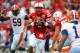 LINCOLN, NE - OCTOBER 5: quarterback Tommy Armstrong Jr. #4 of the Nebraska Cornhuskers looks for an opening in the Illinois Fighting Illini defense during their game at Memorial Stadium on October 5, 2013 in Lincoln, Nebraska. (Photo by Eric Francis/Getty Images)