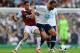 LONDON, ENGLAND - OCTOBER 06: Mousa Dembele of Tottenham (R) is challenged by Ravel Morrison of West Ham during the Barclays Premier League match between Tottenham Hotspur and West Ham United at White Hart Lane on October 6, 2013 in London, England. (Photo by Mike Hewitt/Getty Images)