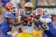 LSU running back Jeremy Hill fights through the arm tackles of Florida defenders.