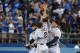 Sep 13, 2013; Los Angeles, CA, USA; San Francisco Giants outfielders Angel Pagan (left), Juan Perez (2) and Hunter Pence leap in celebration at the end of the game against the Los Angeles Dodgers at Dodger Stadium. The Giants defeated the Dodgers 4-2. Mandatory Credit: Kirby Lee-USA TODAY Sports
