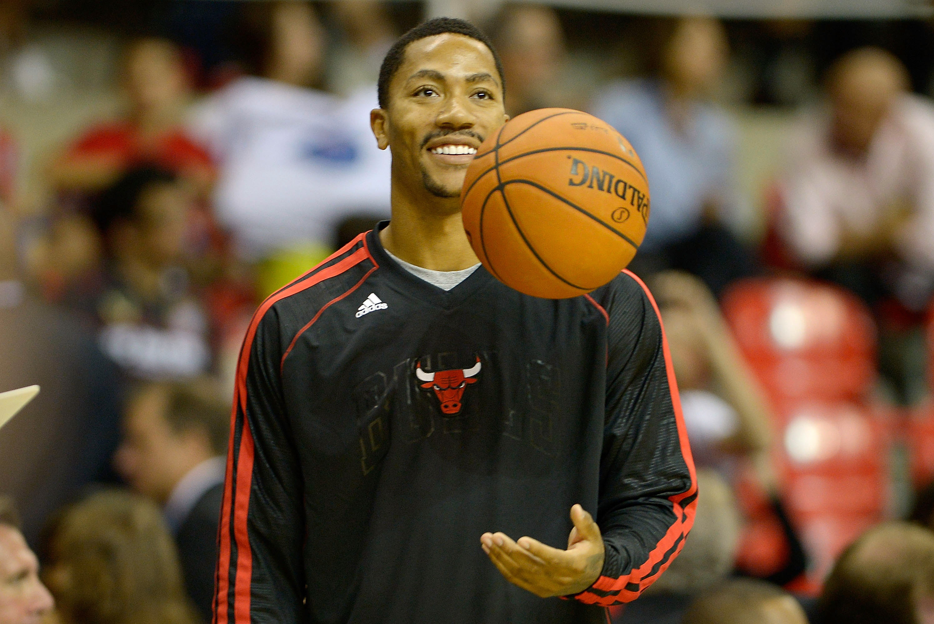 Chicago Bulls' Derrick Rose talks to teammates as he controls the ball  during the third quarter of an NBA basketball game against the New Jersey  Nets in Chicago, Wednesday, April 13, 2011.
