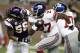 DETROIT, MI - DECEMBER 13: Brandon Jacobs #27 of the New York Giants tries to outrun the tackle of E.J. Henderson #56 of the Minnesota Vikings at Ford Field on December 13, 2010 in Detroit, Michigan. (Photo by Gregory Shamus/Getty Images)