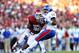 Oct 20, 2012; Norman, OK, USA; Kansas Jayhawks quarterback Michael Cummings (14) is sacked in the first quarter by Oklahoma Sooners defensive end Chuka Ndule (98) at Oklahoma Memorial Stadium. Mandatory Credit: Matthew Emmons-USA TODAY Sports