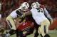 Oct 18, 2013; Louisville, KY, USA; UCF Knights defensive lineman E.J. Dunston (95) tackles Louisville Cardinals running back Senorise Perry (32) during the first quarter of play at Papa John's Cardinal Stadium. Mandatory Credit: Jamie Rhodes-USA TODAY Sports