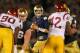 SOUTH BEND, IN - OCTOBER 19: Tommy Rees #11 of the Notre Dame Fighting Irish looks for a receiver as George Uko #90 and Devon Kennard #42 of the University of Southern Califonia Trojans rush at Notre Dame Stadium on October 19, 2013 in South Bend, Indiana. (Photo by Jonathan Daniel/Getty Images)