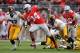 COLUMBUS, OH - OCTOBER 19: Carlos Hyde #34 of the Ohio State Buckeyes spins away from defenders John Lowdermilk #37 of the Iowa Hawkeyes and Anthony Hitchens #31 of the Iowa Hawkeyes in the second quarter for a 17-yard gain at Ohio Stadium on October 19, 2013 in Columbus, Ohio. (Photo by Jamie Sabau/Getty Images)