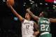 Oct 15, 2013; Brooklyn, NY, USA; Brooklyn Nets point guard Jorge Gutierrez (12) drives to the basket against Boston Celtics shooting guard Jordan Crawford (27) in the fourth quarter of pre-season NBA game at Barclays Center. Mandatory Credit: Noah K. Murray-USA TODAY Sports