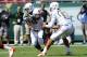 Miami QB Stephen Morris handing the ball off to RB Duke Johnson.
