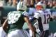 Oct 20, 2013; East Rutherford, NJ, USA; New England Patriots quarterback Tom Brady (12) looks to pass while under pressure from New York Jets defensive end Quinton Coples (98) during the first half at MetLife Stadium. Mandatory Credit: Ed Mulholland-USA TODAY Sports