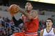 Oct 23, 2013; Wichita, KS, USA; Chicago Bulls guard Derrick Rose (1) drives to the basket past Oklahoma City Thunder center Steven Adams (12) during the first half at Intrust Bank Arena. Chicago won 104-95. Mandatory Credit: Peter G. Aiken-USA TODAY Sports