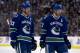 VANCOUVER, CANADA - JANUARY 23: Daniel Sedin #22 of the Vancouver Canucks talk things over with teammate and twin brother Henrik Sedin #33 before a face-off during NHL action against the Calgary Flames on January 23, 2013 at Rogers Arena in Vancouver, British Columbia, Canada. (Photo by Rich Lam/Getty Images)