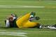 GREEN BAY, WI - NOVEMBER 04: Aaron Rodgers #12 of the Green Bay Packers lays on the ground after being sacked by Shea McClellin of the Chicago Bears at Lambeau Field on November 4, 2013 in Green Bay, Wisconsin. (Photo by Jonathan Daniel/Getty Images)