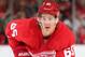 DETROIT, MI - OCTOBER 26: Danny DeKeyser #65 of the Detroit Red Wings gets set for the face-off during an NHL game against the New York Rangers at Joe Louis Arena on October 26, 2013 in Detroit, Michigan. The Rangers win in O.T. 3-2 (Photo by Dave Reginek/NHLI via Getty Images)
