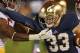 SOUTH BEND, IN - OCTOBER 19: Cam McDaniel #33 of the Notre Dame Fighting Irish fights off Josh Shaw #6 of the University of Southern California Trojans at Notre Dame Stadium on October 19, 2013 in South Bend, Indiana. Notre Dame defeated USC 14-10. (Photo by Jonathan Daniel/Getty Images)