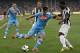 BEIJING, CHINA - AUGUST 11: Christian Maggio (L) of SSC Napoli challenges Gerald Asamoah of Juventus FC during the Italian Super Cup 2012 match at China's National Stadium on August 11, 2012 in Beijing, China. (Photo by Lintao Zhang/Getty Images)
