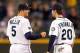 SEATTLE, WA - SEPTEMBER 28: Brad Miller #5 and Nick Franklin #20 of the Seattle Mariners celebrate after defeating the Oakland Athletics 7-5 at Safeco Field on September 28, 2013 in Seattle, Washington. (Photo by Otto Greule Jr/Getty Images)