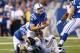 INDIANAPOLIS, IN - NOVEMBER 10: Andrew Luck #12 of the Indianapolis Colts runs is tackled by Chris Long #91 of the St. Louis Rams during the game at Lucas Oil Stadium on November 10, 2013 in Indianapolis, Indiana. (Photo by Andy Lyons/Getty Images)
