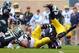 Nov 2, 2013; East Lansing, MI, USA; Michigan Wolverines quarterback Devin Gardner (98) is up ended by Michigan State Spartans safety Kurtis Drummond (27) during the 1st half of a game at Spartan Stadium. Mandatory Credit: Mike Carter-USA TODAY Sports