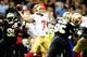 NEW ORLEANS, LA - NOVEMBER 25: Colin Kaepernick #7 of the San Francisco 49ers drops back to pass while under pressure during a game against the New Orleans Saints at the Mercedes-Benz Superdome on November 25, 2012 in New Orleans, Louisiana. (Photo by Stacy Revere/Getty Images)