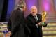 CAPE TOWN, SOUTH AFRICA - DECEMBER 04: FIFA President Sepp Blatter (R) holds the World Cup next to South African President Jacob Zuma (C) during the Final Draw for the FIFA World Cup 2010 December 4, 2009 at the International Convention Centre in Cape Town, South Africa. (Photo by Shaun Botterill/Getty Images)