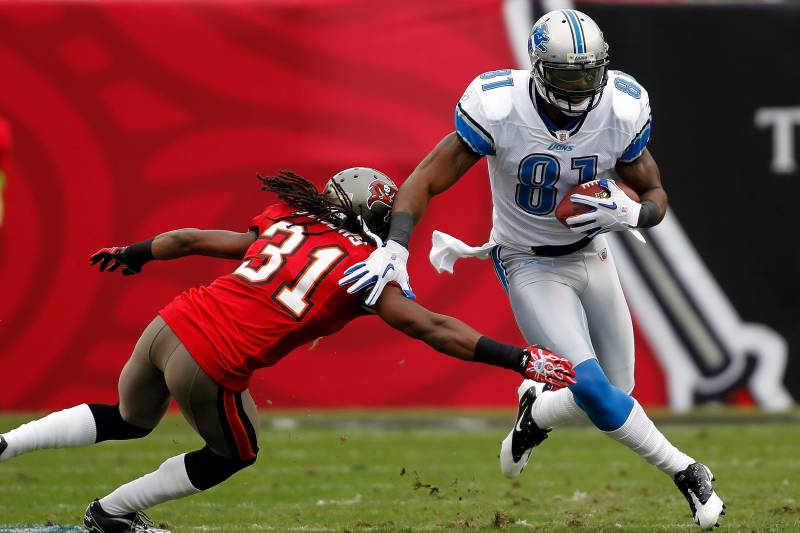 TAMPA, FL - DECEMBER 19:  Receiver Calvin Johnson #81 of the Detroit Lions runs through the tackle of defensive back E.J. Biggers #31 of the Tampa Bay Buccaneers during the game at Raymond James Stadium on December 19, 2010 in Tampa, Florida.  (Photo by J. Meric/Getty Images)