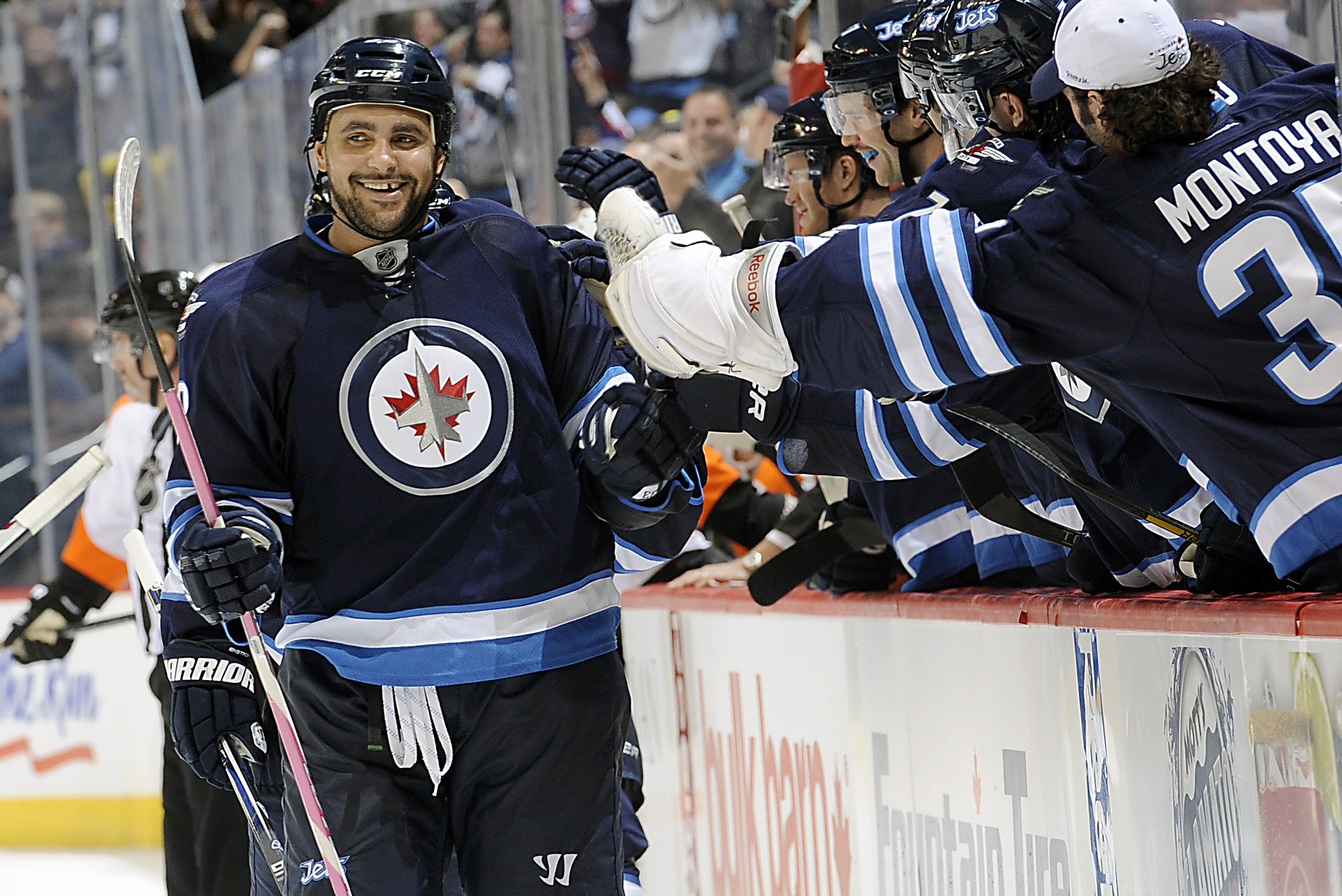 Winnipeg Jets' Dustin Byfuglien (33) stands up to a check by
