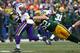 GREEN BAY, WI - NOVEMBER 24: Adrian Peterson #28 of the Minnesota Vikings slips a tackle by Clay Matthews #52 of the Green Bay Packers at Lambeau Field on November 24, 2013 in Green Bay, Wisconsin. The Vikings and the Packers tied 26-26 after overtime. (Photo by Jonathan Daniel/Getty Images)