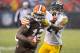 CLEVELAND, OH - NOVEMBER 24: Wide receiver Josh Gordon #12 of the Cleveland Browns completes a pass for a first down while under pressure from cornerback Ike Taylor #24 of the Pittsburgh Steelers during the second half at FirstEnergy Stadium on November 24, 2013 in Cleveland, Ohio. The Steelers defeated the Browns 27-11. (Photo by Jason Miller/Getty Images)