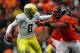 CORVALLIS, OR - NOVEMBER 24: Marcus Mariota #8 of the Oregon Ducks is pressured by Scott Crichton #95 of the Oregon State Beavers during the 116th Civil War on November 24, 2012 at the Reser Stadium in Corvallis, Oregon. (Photo by Jonathan Ferrey/Getty Images)