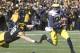 IOWA CITY, IA - NOVEMBER 23: Quarterback Devin Gardner #98 of the Michigan Wolverines breaks a tackle during the second quarter by defensive lineman Mike Hardy #98 of the Iowa Hawkeyes on November 23, 2013 at Kinnick Stadium in Iowa City, Iowa. (Photo by Matthew Holst/Getty Images)