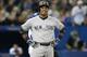 TORONTO, CANADA - SEPTEMBER 18: Robinson Cano #24 of the New York Yankees reacts after his groundball just stayed fair resulting in a groundout in the sixth inning during MLB game action against the Toronto Blue Jays on September 18, 2013 at Rogers Centre in Toronto, Ontario, Canada. (Photo by Tom Szczerbowski/Getty Images)