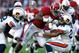 TUSCALOOSA, AL - NOVEMBER 24: T.J. Yeldon #4 of the Alabama Crimson Tide rushes over T'Sharvan Bell #22 and Ryan Smith #24 of the Auburn Tigers at Bryant-Denny Stadium on November 24, 2012 in Tuscaloosa, Alabama. (Photo by Kevin C. Cox/Getty Images)