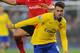 CARDIFF, WALES - NOVEMBER 30: Aaron Ramsey of Arsenal gets past Don Cowie (L) of Cardiff during the Barclays Premier League match between Cardiff City and Arsenal at Cardiff City Stadium on November 30, 2013 in Cardiff, Wales. (Photo by Mike Hewitt/Getty Images)